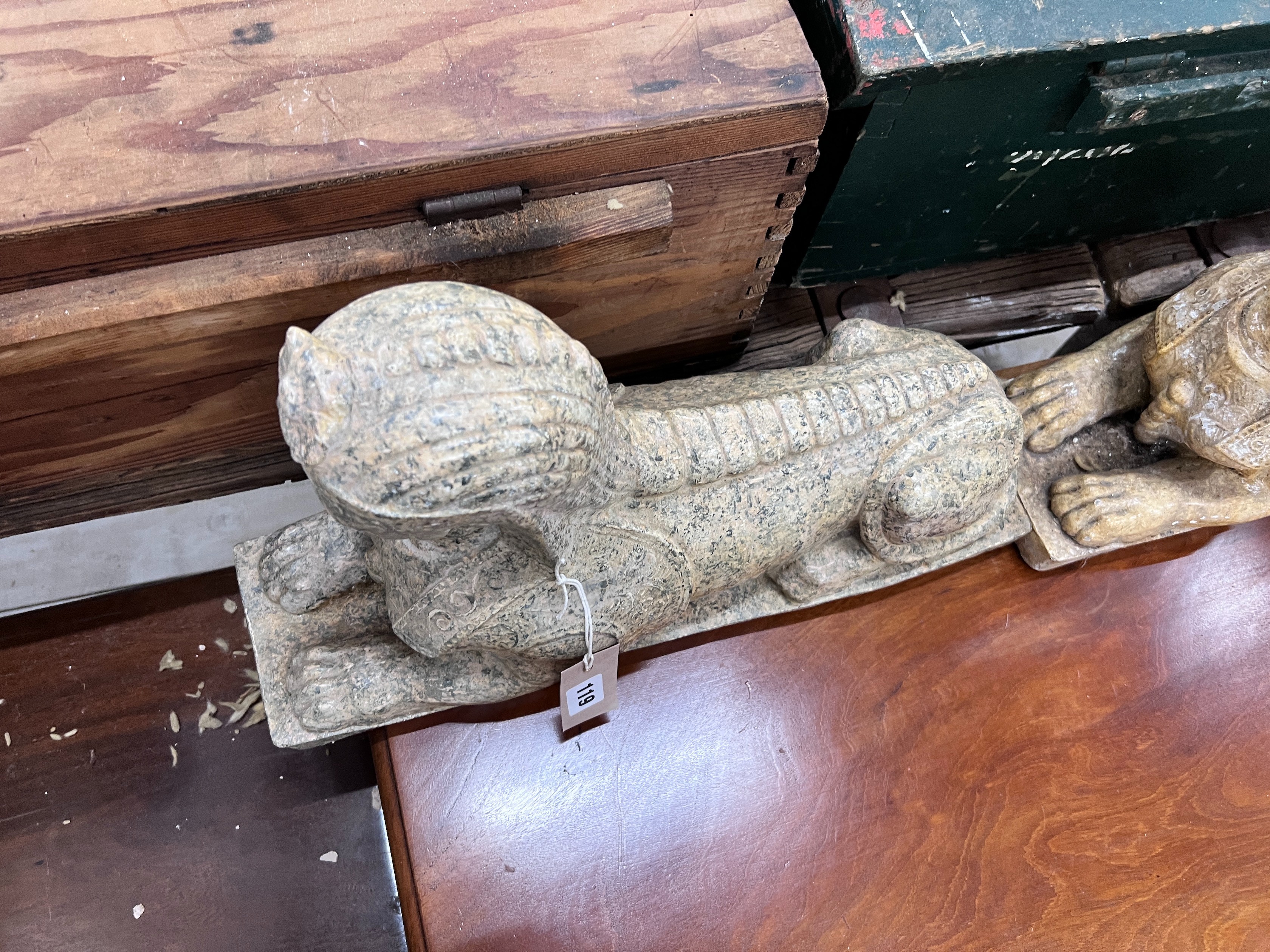A pair of composition faux marble sphinx, length 48cm, height 30cm *Please note the sale commences at 9am.